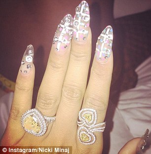 More is more: Nicki Minaj, right, matches her nail art with her diamonds while Rita Ora, left, opts for fun designs