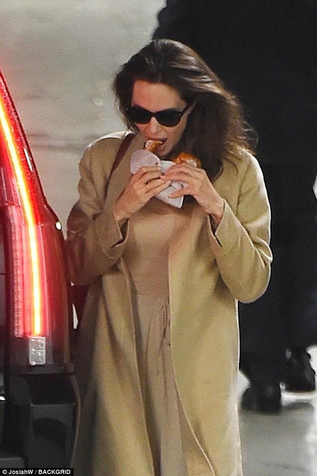 Not afraid of carbs! Angelina Jolie seems to be doing just fine on her own as she munched on a hot pretzel in New York on Wednesday